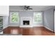 Spacious living room with hardwood floors, a cozy fireplace, and lots of natural light at 5029 David Pl, Smyrna, GA 30082