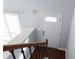 Staircase with wood and metal railing, leading to a bright white door with decorative glass at 5029 David Pl, Smyrna, GA 30082