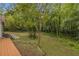 View of the backyard with a tree and plenty of surrounding trees at 1997 N Landing Way, Marietta, GA 30066