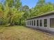 A long, narrow backyard with modern home, full of large windows, and surrounded by lush trees and plants at 1997 N Landing Way, Marietta, GA 30066