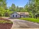 Charming home with manicured front yard and a circular driveway surrounded by mature trees at 1997 N Landing Way, Marietta, GA 30066