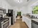 Well-lit kitchen with stainless steel appliances and white cabinets, conveniently located near the dining area at 1997 N Landing Way, Marietta, GA 30066