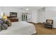Bright main bedroom boasts hardwood floors, ceiling fan, walkout to sunroom, and decor pillows at 1997 N Landing Way, Marietta, GA 30066