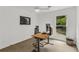 Home office features natural light and view to wooded yard, modern desk and ergonomic chair at 1997 N Landing Way, Marietta, GA 30066