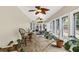 Sunroom boasts tile floors, walls of windows with wooded view, workout equipment and potted plants at 1997 N Landing Way, Marietta, GA 30066
