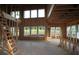 Interior space features exposed wood framing, tall ceilings, and large window openings ready for finishing at 4720 Briscoe Dr, Cumming, GA 30028