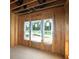 Interior space features exposed wood framing, tall ceilings, and large window openings ready for finishing at 4720 Briscoe Dr, Cumming, GA 30028