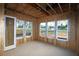 Interior with exposed framing and large window openings, exemplifying the house's structural elements at 4720 Briscoe Dr, Cumming, GA 30028