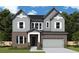 Charming two-story home featuring a brick facade, gray siding, and an attached two-car garage at 4720 Briscoe Drive, Cumming, GA 30028