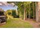 A view of the private backyard with lush lawn and surrounding mature trees at 5028 Winding Hills Ln, Woodstock, GA 30189