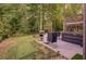 Enjoy the backyard, complete with putting green, outdoor kitchen, hot tub, and two-story deck at 5028 Winding Hills Ln, Woodstock, GA 30189
