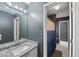 Bathroom featuring a granite countertop, and gray walls with shower in background at 5028 Winding Hills Ln, Woodstock, GA 30189