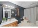 Full bathroom features tiled flooring, a vanity, and a tub and shower combo at 5028 Winding Hills Ln, Woodstock, GA 30189
