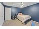 Cozy bedroom featuring neutral carpet, with bed, and navy blue walls at 5028 Winding Hills Ln, Woodstock, GA 30189
