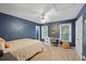 Comfortable bedroom featuring neutral carpet, desk, and navy blue walls at 5028 Winding Hills Ln, Woodstock, GA 30189