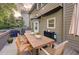 Back deck with wooden table and chairs, barbecue, and lovely backyard at 5028 Winding Hills Ln, Woodstock, GA 30189