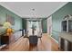 Elegant dining room featuring hardwood floors, crown molding, and a modern chandelier at 5028 Winding Hills Ln, Woodstock, GA 30189