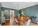 Cozy dining room with a wooden table, hardwood floors, and neutral decor at 5028 Winding Hills Ln, Woodstock, GA 30189
