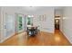 Cozy dining room with hardwood floors, table, and stools near a bright window at 5028 Winding Hills Ln, Woodstock, GA 30189
