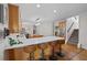 Eat-in kitchen features a large counter with seating, stainless appliances, and wood floors at 5028 Winding Hills Ln, Woodstock, GA 30189