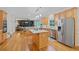 Spacious open kitchen with stainless steel appliances, island, and light wood cabinets at 5028 Winding Hills Ln, Woodstock, GA 30189