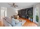 Cozy living room with a stylish fireplace, built-in bookshelves, and hardwood floors at 5028 Winding Hills Ln, Woodstock, GA 30189