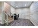 Basement with wood-paneled walls, laminate floors, staircase, and small desk area at 527 Cass White Nw Rd, Cartersville, GA 30121