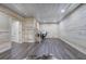 Basement featuring wood-paneled walls, laminate floors, multiple doorways, and staircase at 527 Cass White Nw Rd, Cartersville, GA 30121