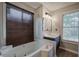 Bathroom with a large soaking tub, single vanity, and natural light from a large window at 527 Cass White Nw Rd, Cartersville, GA 30121