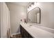 Bright bathroom with white countertop, dark cabinets, and large mirror at 527 Cass White Nw Rd, Cartersville, GA 30121