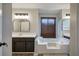 Bathroom with a large soaking tub, double vanity, and natural light from a large window at 527 Cass White Nw Rd, Cartersville, GA 30121