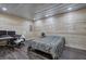 Bedroom featuring wood-paneled walls, laminate floors, and desk area at 527 Cass White Nw Rd, Cartersville, GA 30121