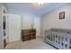 Neutral Bedroom featuring a crib, dresser, and ample natural light at 527 Cass White Nw Rd, Cartersville, GA 30121