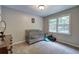 Cozy Bedroom with a crib, dresser, and large window overlooking the yard at 527 Cass White Nw Rd, Cartersville, GA 30121