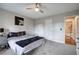 Bright bedroom with plush carpet, a ceiling fan, and an attached bathroom at 527 Cass White Nw Rd, Cartersville, GA 30121