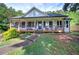 Charming home with a covered porch, complemented by mature landscaping at 527 Cass White Nw Rd, Cartersville, GA 30121