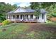 Inviting home with a classic front porch, lush greenery, and a well-kept lawn at 527 Cass White Nw Rd, Cartersville, GA 30121