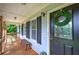 Inviting front porch with a wreath, bench and a view of the surrounding neighborhood at 527 Cass White Nw Rd, Cartersville, GA 30121