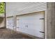 Detached two car garage with white doors at 527 Cass White Nw Rd, Cartersville, GA 30121