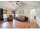 Spacious living room with hardwood floors, vaulted ceiling, leather furniture, and neutral paint at 527 Cass White Nw Rd, Cartersville, GA 30121