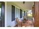 Charming covered front porch with rocking chairs and natural wood accents at 527 Cass White Nw Rd, Cartersville, GA 30121
