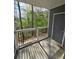 Cozy covered balcony with black metal railing overlooks the surrounding green trees at 1202 Santa Fe Pkwy, Atlanta, GA 30350