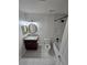 A renovated bathroom with a granite countertop vanity, tile floors, and a tiled shower/tub combo at 1202 Santa Fe Pkwy, Atlanta, GA 30350