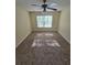 A bright bedroom features carpeted floors and one window letting in natural light, and a ceiling fan at 1202 Santa Fe Pkwy, Atlanta, GA 30350