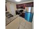This modern kitchen features stainless steel appliances, granite countertops and dark wood cabinetry at 1202 Santa Fe Pkwy, Atlanta, GA 30350