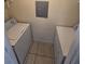 The laundry room features a side by side washer and dryer, and tile flooring at 1202 Santa Fe Pkwy, Atlanta, GA 30350