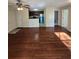 A spacious living room features hardwood floors and a view into the modern kitchen with stainless steel appliances at 1202 Santa Fe Pkwy, Atlanta, GA 30350
