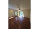 This living room is a spacious area offering access to an outdoor balcony, hardwood floors and a ceiling fan at 1202 Santa Fe Pkwy, Atlanta, GA 30350