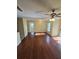 A spacious living room features hardwood floors, a ceiling fan and sliding door access to the exterior of the home at 1202 Santa Fe Pkwy, Atlanta, GA 30350