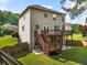This home features a two-story deck and patio with backyard grass surrounded by a classic wooden fence at 1925 Piedmont Cove Ln, Cumming, GA 30040
